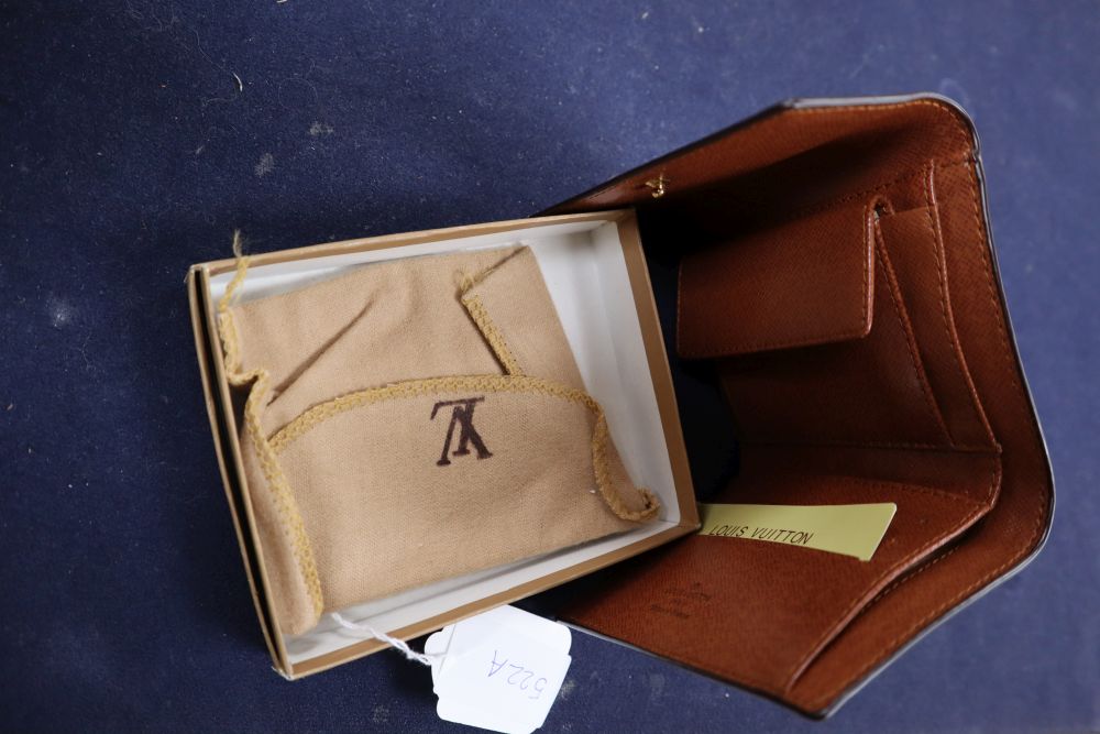 A Louis Vuitton purse, with pouch and box.